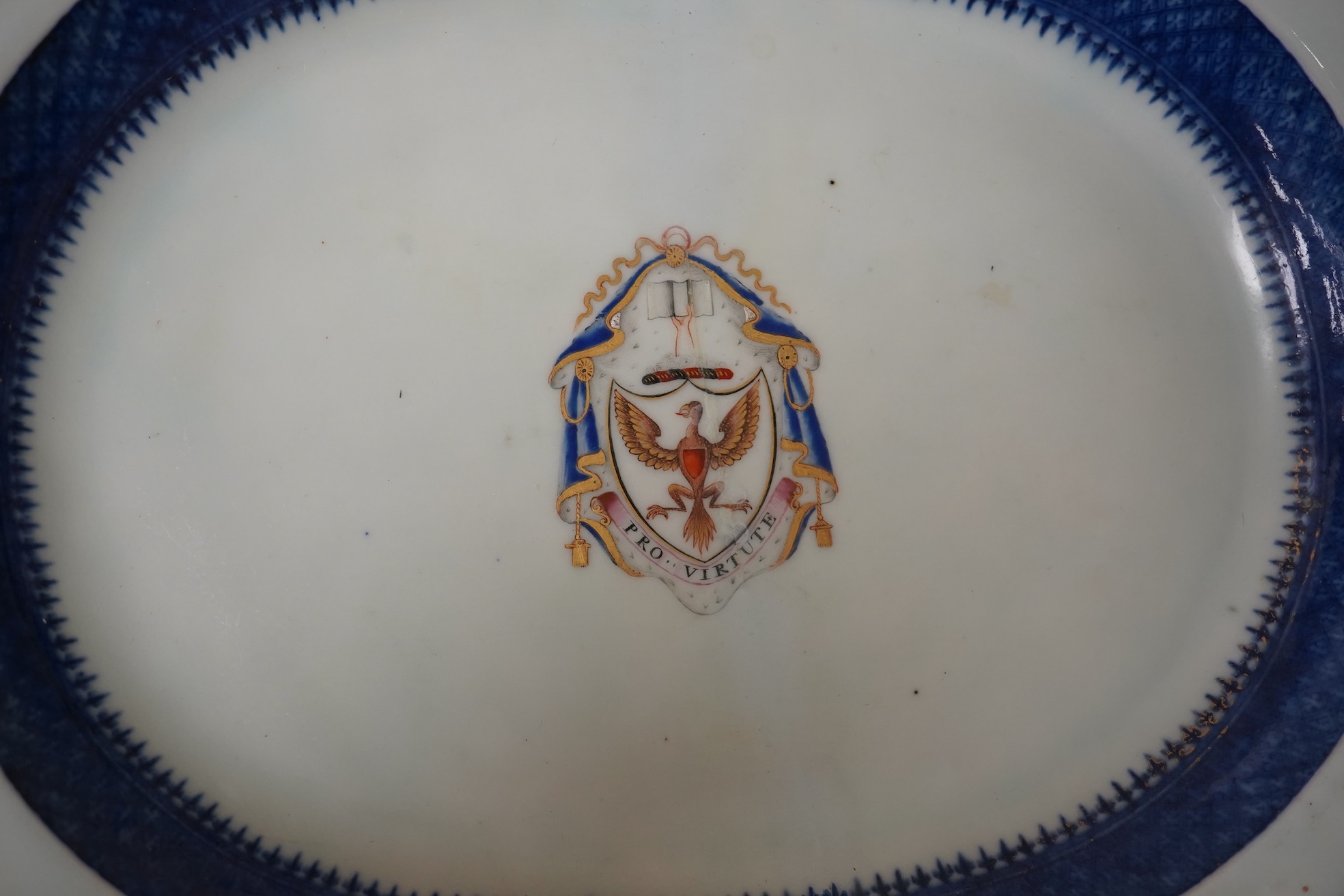 A late 18th century Chinese export armorial oval dish with Pro Virtute armorial, 37cm. Condition - restored